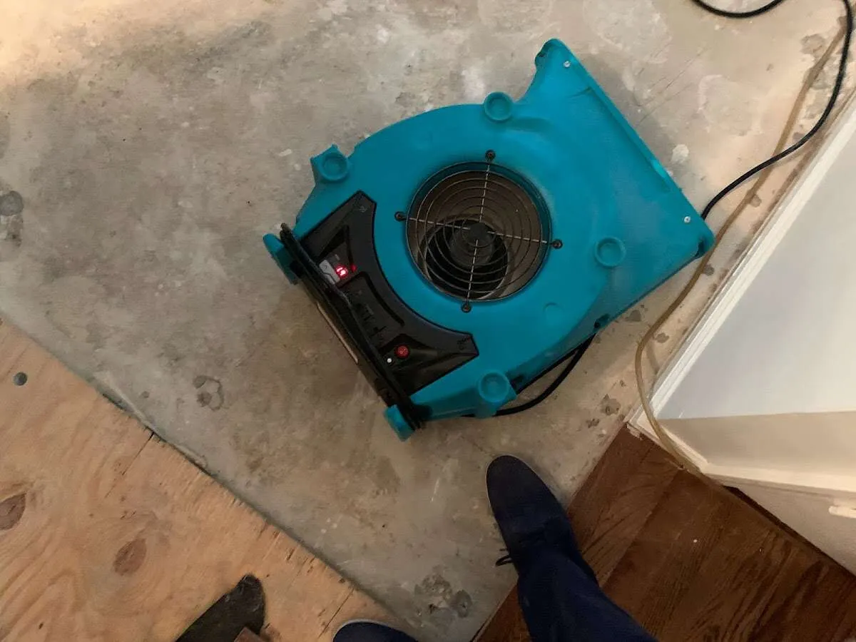 Air mover drying subfloor during Commercial Water Damage Restoration in Grand Island
